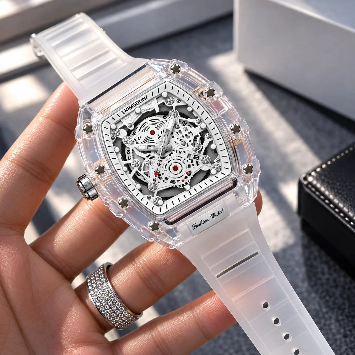Hudson Mercury Tervoque B21 white tonneau skeleton watch held in hand showing transparent case and strap