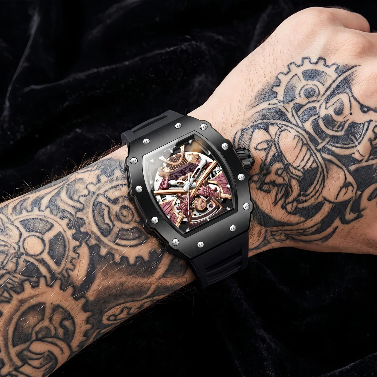 Hudson Mercury Kurojin A990 men’s skeleton watch worn on a tattooed wrist